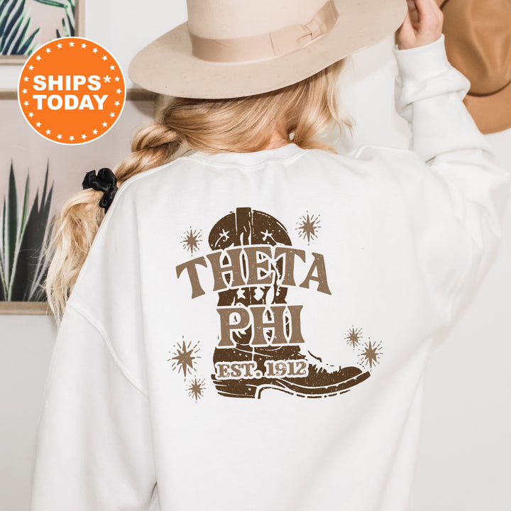 a woman wearing a white sweatshirt with a cowboy hat on her head
