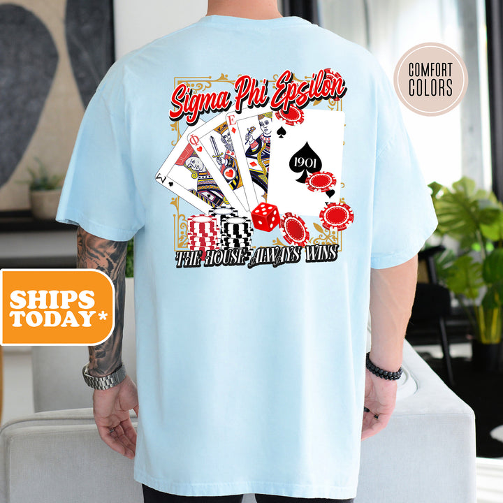 a man wearing a light blue shirt with a picture of playing cards on it