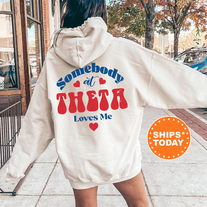 a woman in a white hoodie that says somebody at their loves me