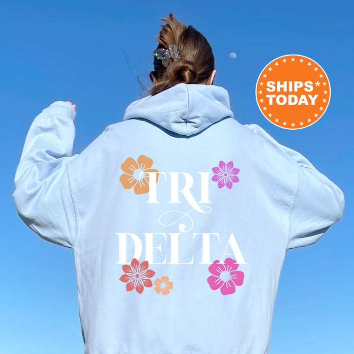 a woman wearing a white hoodie with flowers on it