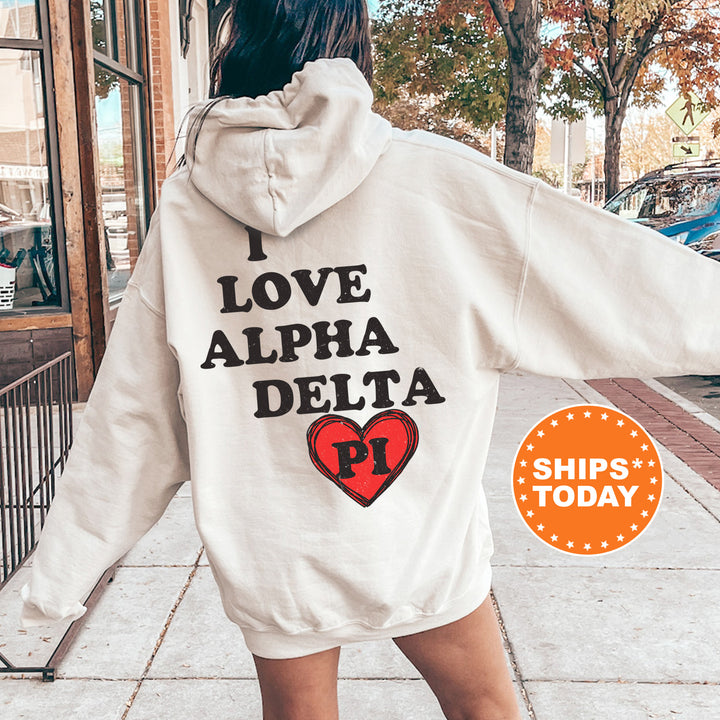 a woman in a white hoodie that says i love alpha delta