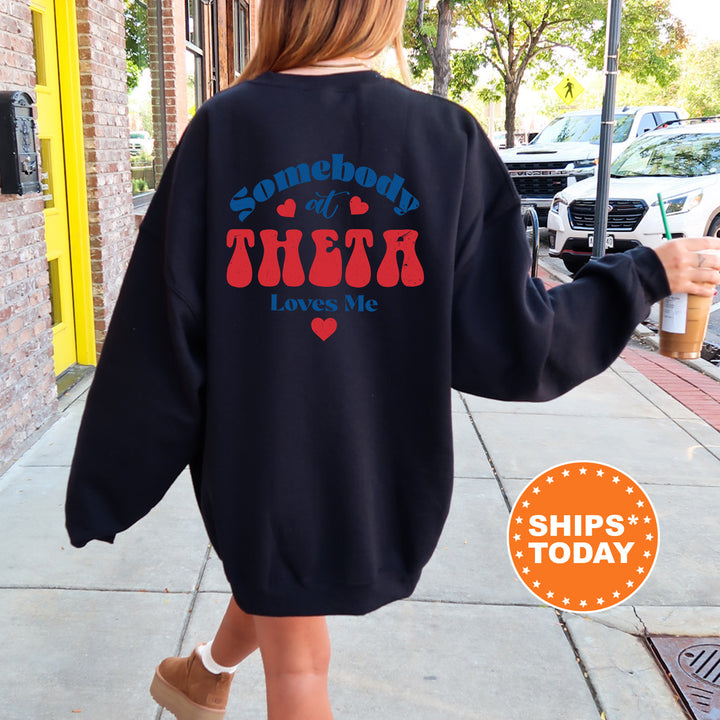 a woman walking down a sidewalk wearing a sweatshirt