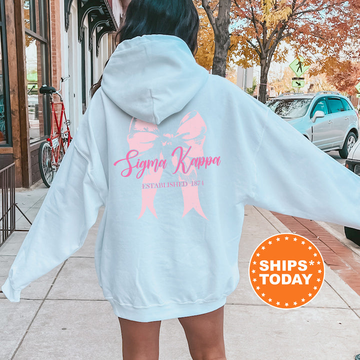 a woman in a white hoodie is walking down the street