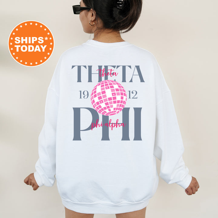 a woman wearing a white sweatshirt with the words thea phi on it