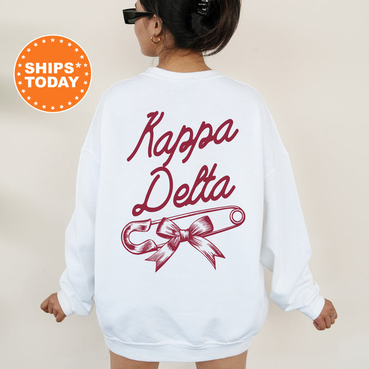 a woman wearing a white sweatshirt with the words kapppa delta on it