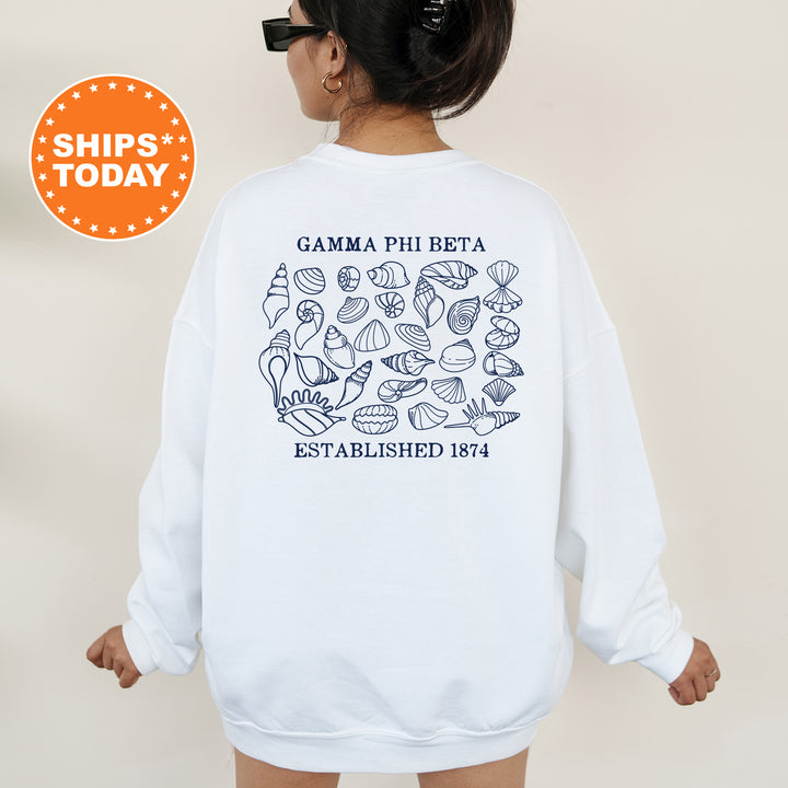 a woman wearing a white sweatshirt with the words gama phi beta established 1974