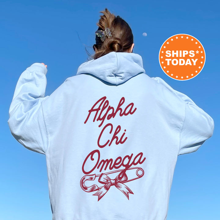 a woman wearing a white hoodie with the words aphela chi omega on
