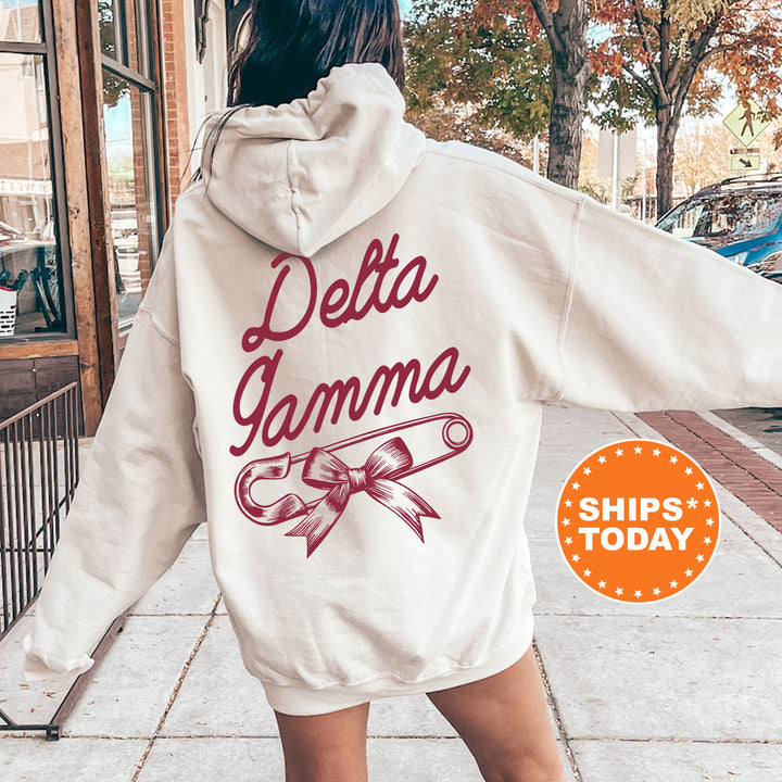 a woman walking down a sidewalk wearing a white hoodie