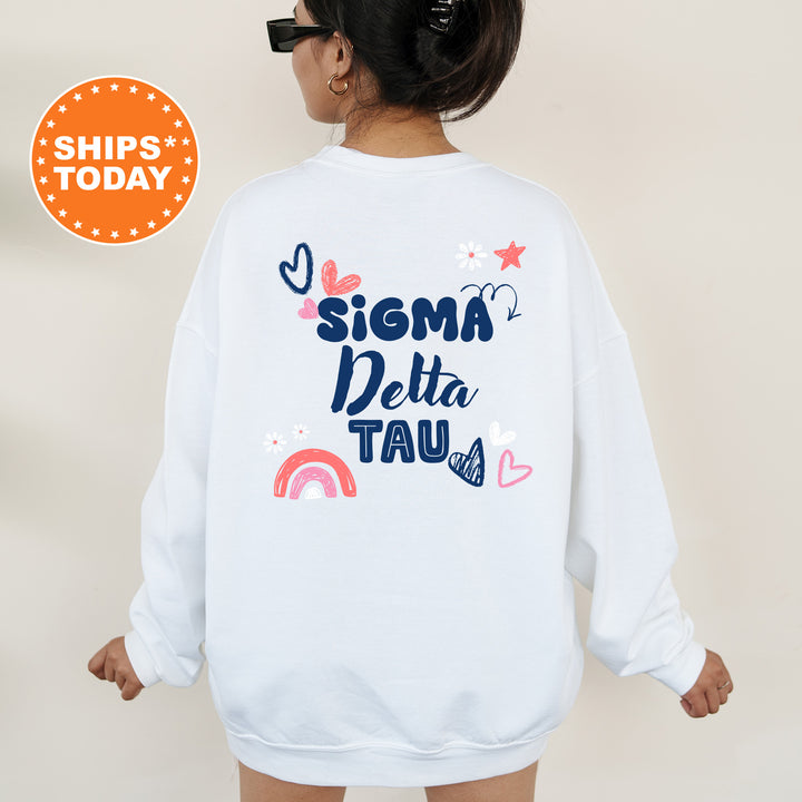 a woman wearing a white sweatshirt with the words sigma delta tau on it