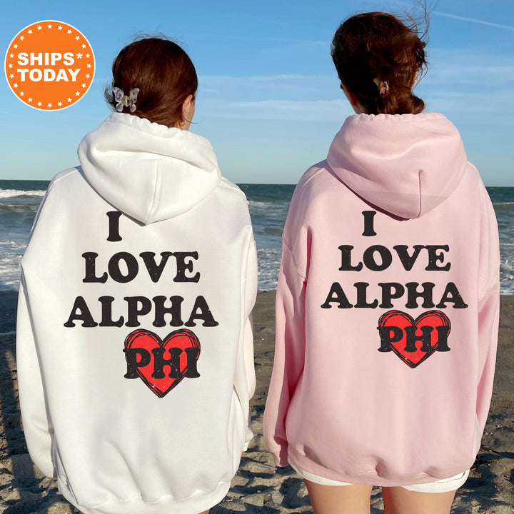 two women wearing matching sweatshirts on the beach