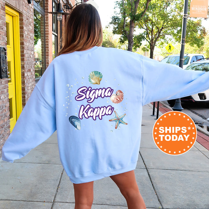 a woman walking down a sidewalk wearing a blue sweatshirt