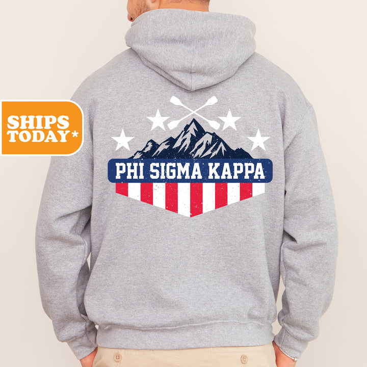 a man wearing a gray hoodie with the phi sigm kapa logo on