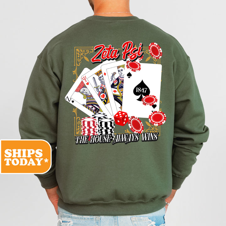 a man wearing a green sweatshirt with playing cards on it