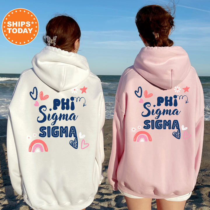 two girls wearing pink and white sweatshirts on the beach