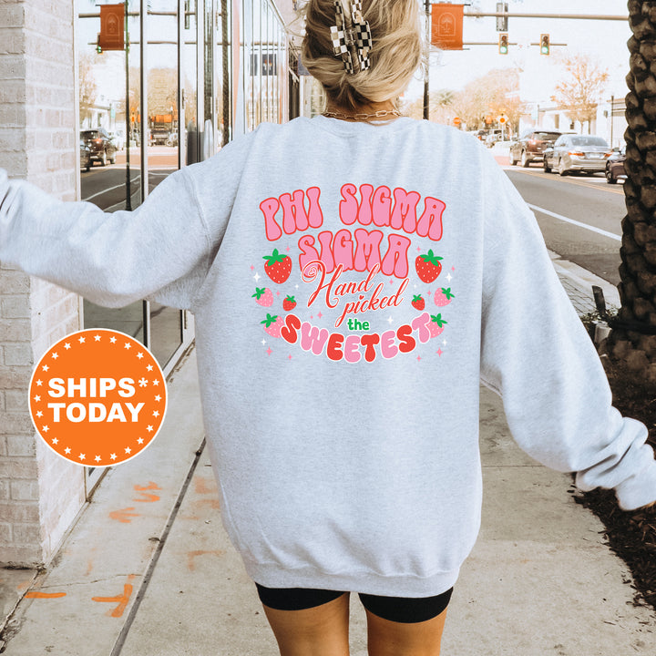 a woman walking down a sidewalk wearing a sweatshirt