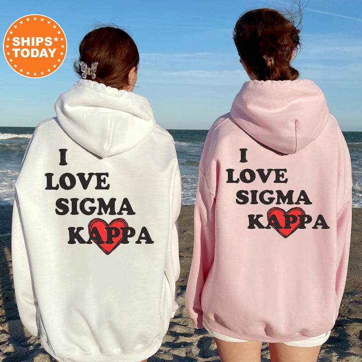 two women wearing matching sweatshirts on the beach