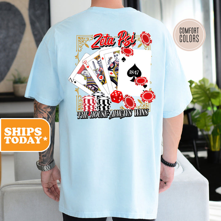 a man wearing a blue shirt with a picture of playing cards on it
