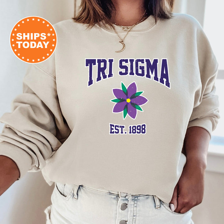 a woman wearing a sweatshirt with a flower on it