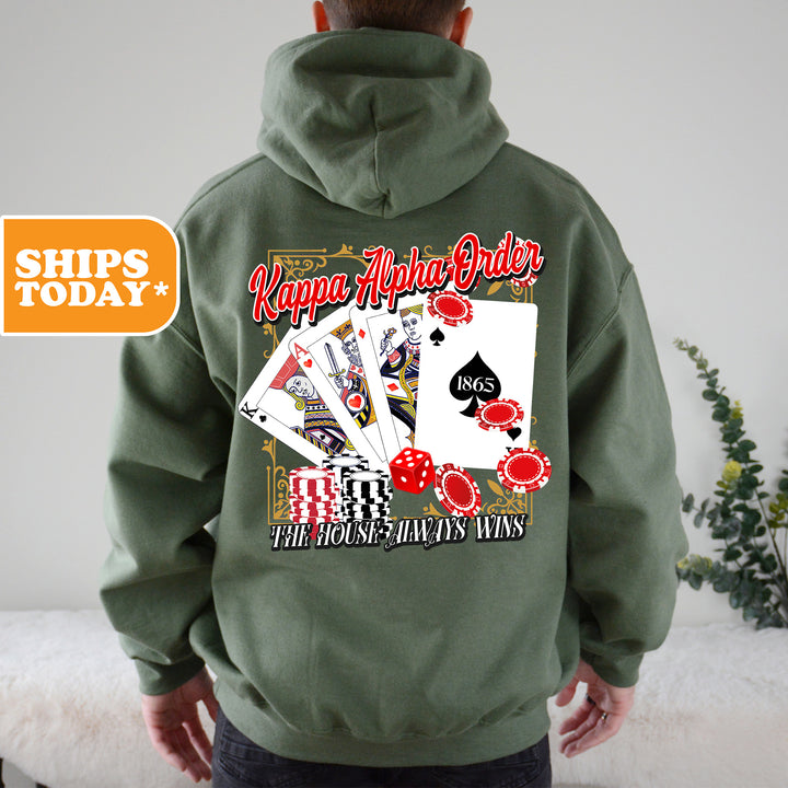a man wearing a green hoodie with a picture of playing cards on it
