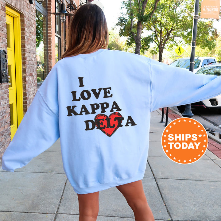 a woman walking down a sidewalk wearing a blue sweatshirt