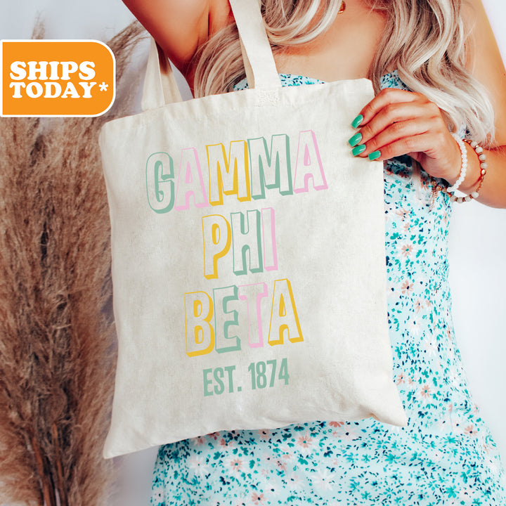 a woman holding a tote bag with the words gumma pili beta