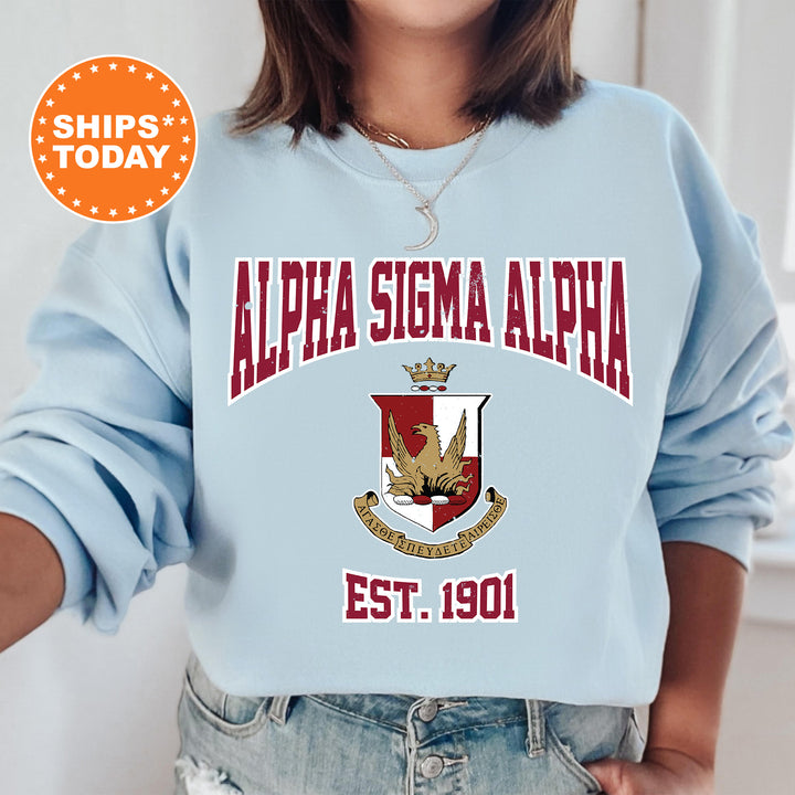 a woman wearing a blue sweatshirt with a crest on it