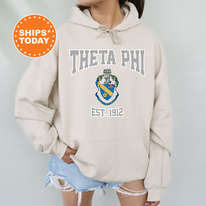 a woman wearing a sweatshirt that says thea phi est 1932