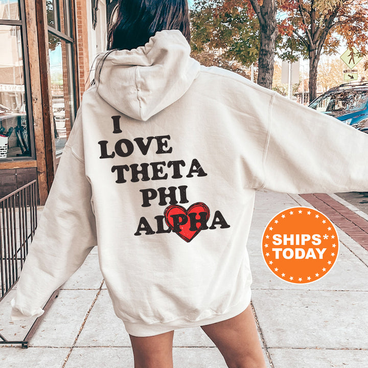 a woman walking down a sidewalk wearing a white hoodie