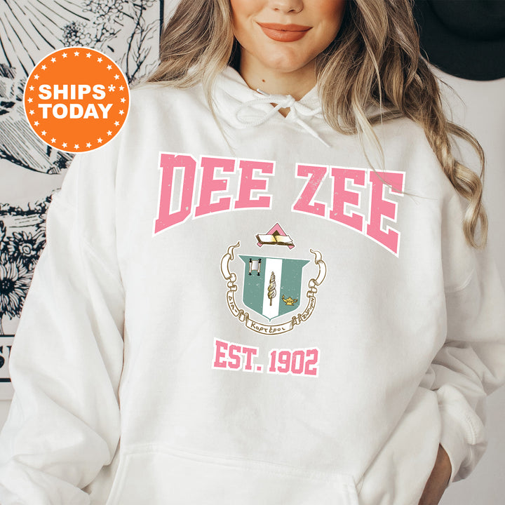 a woman wearing a white hoodie with a crest on it