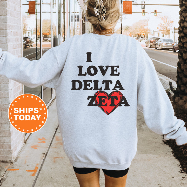 a woman walking down a sidewalk wearing a sweatshirt