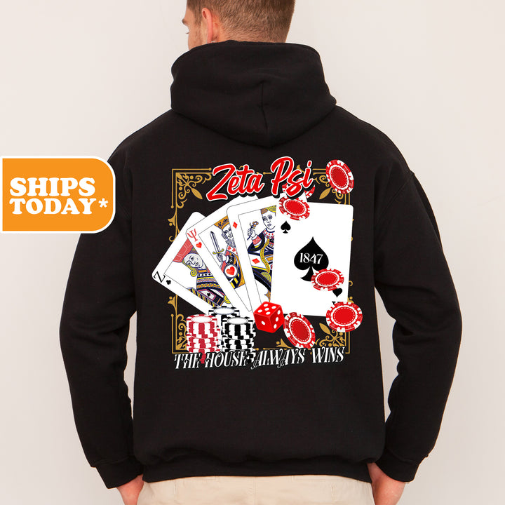 a man wearing a black hoodie with playing cards on it