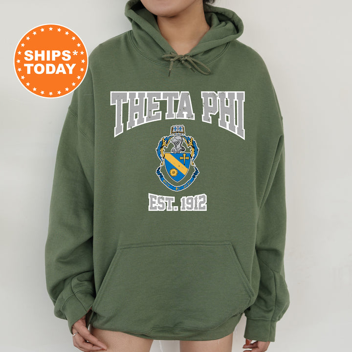 a woman wearing a green hoodie with a phi phi on it