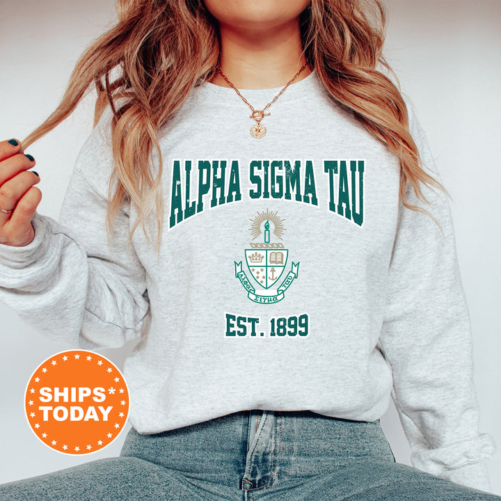 a woman wearing a sweatshirt that says alpha sigm tau est 1989