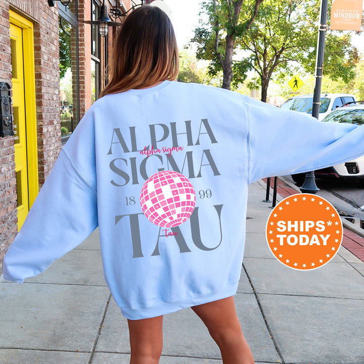 a woman walking down a sidewalk wearing a blue sweatshirt