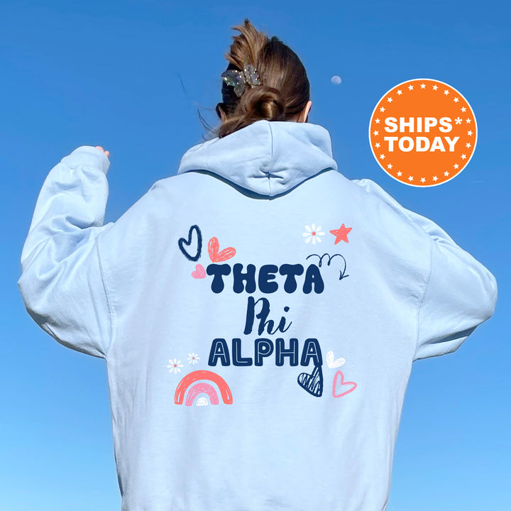 a woman wearing a white hoodie that says, they're in alpha