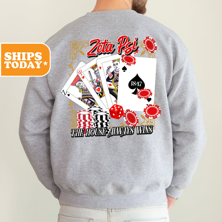 a man wearing a sweatshirt that has a picture of playing cards on it