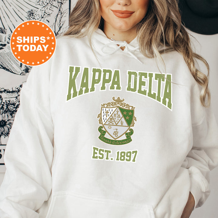 a woman wearing a white hoodie with the words kappa delta est 1897
