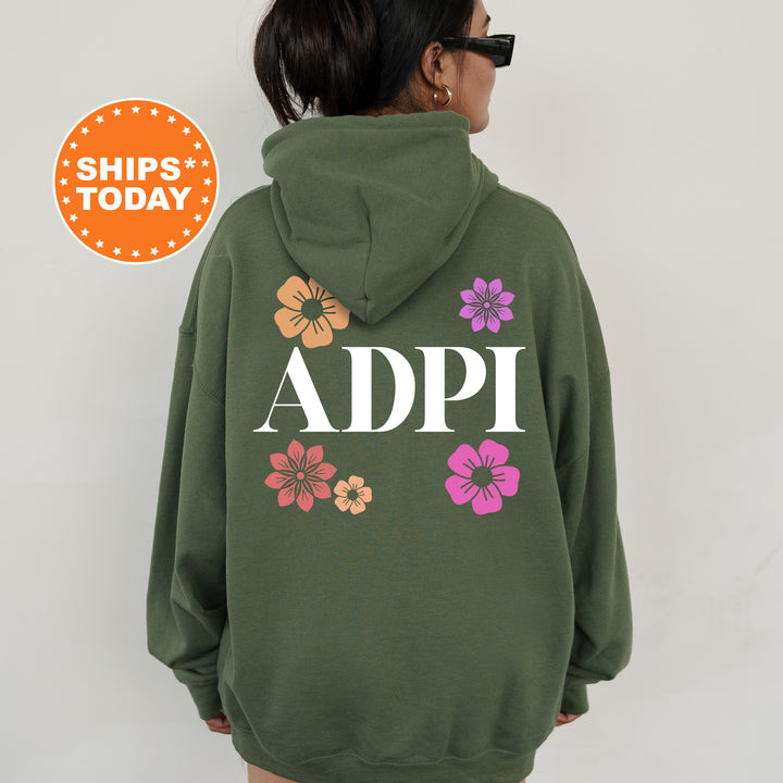 a woman wearing a green hoodie with flowers on it
