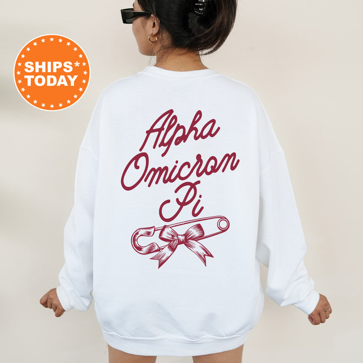 a woman wearing a white sweatshirt with a red ribbon on it