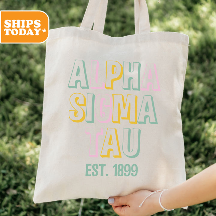 a person holding a white bag with the words alpha sema iau on it