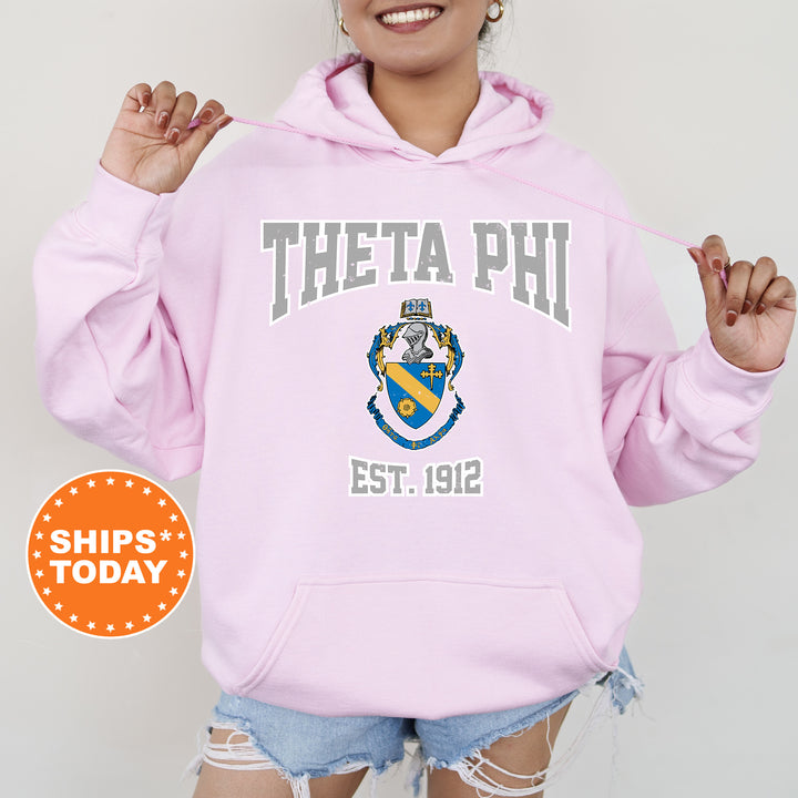 a woman wearing a pink hoodie with a phi phi on it