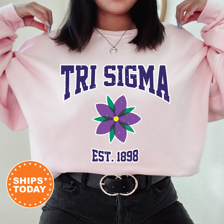 a woman wearing a pink shirt with a flower on it