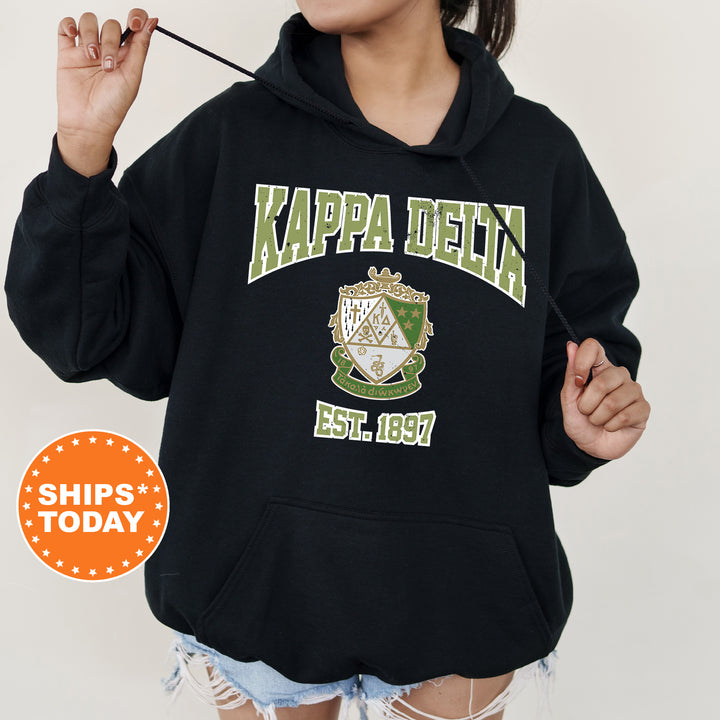 a woman wearing a black kapa delta hoodie