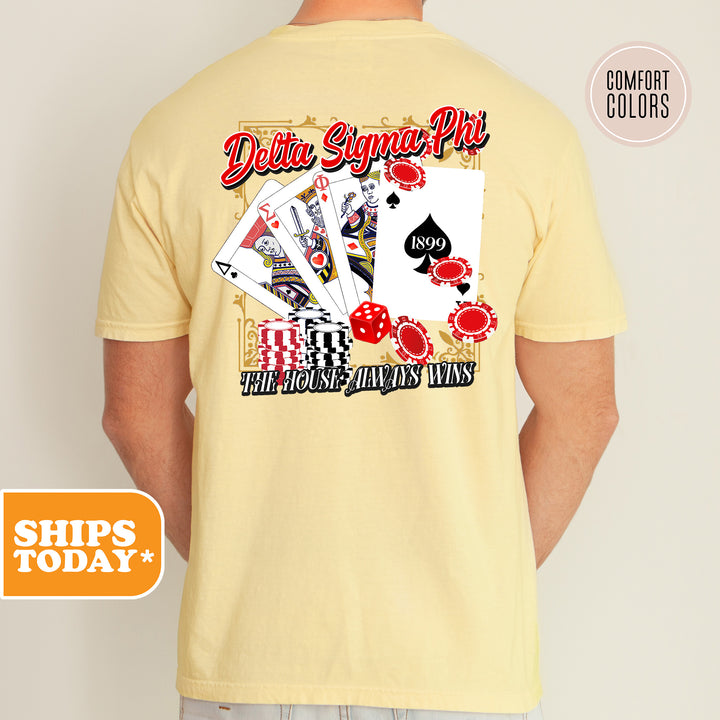 a man wearing a yellow shirt with a picture of playing cards on it