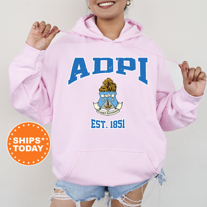 a woman wearing a pink hoodie with the words adpi on it
