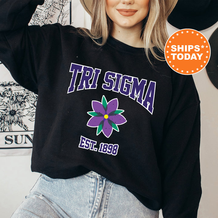 a woman wearing a black shirt with a flower on it