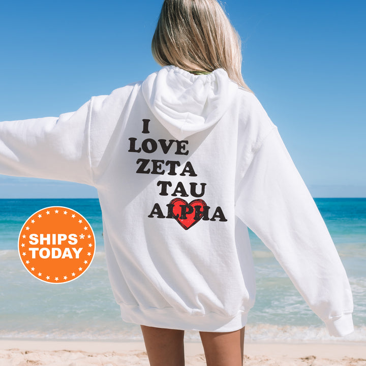 a woman standing on a beach with her back to the camera