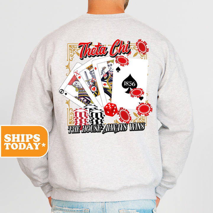 a man wearing a sweatshirt that has a picture of playing cards on it