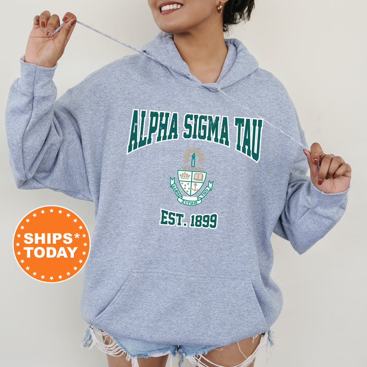 a woman wearing a blue sweatshirt with a green and white logo on it