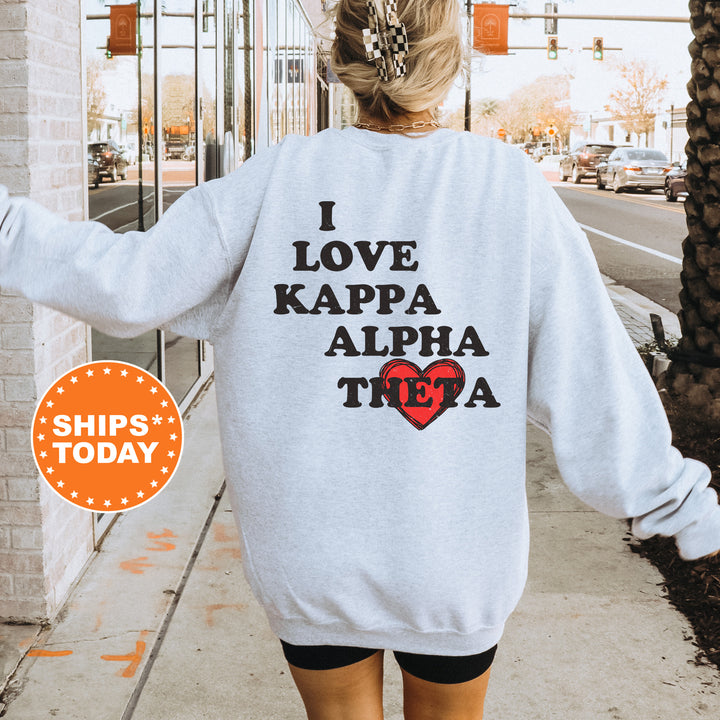 a woman walking down a sidewalk wearing a sweatshirt